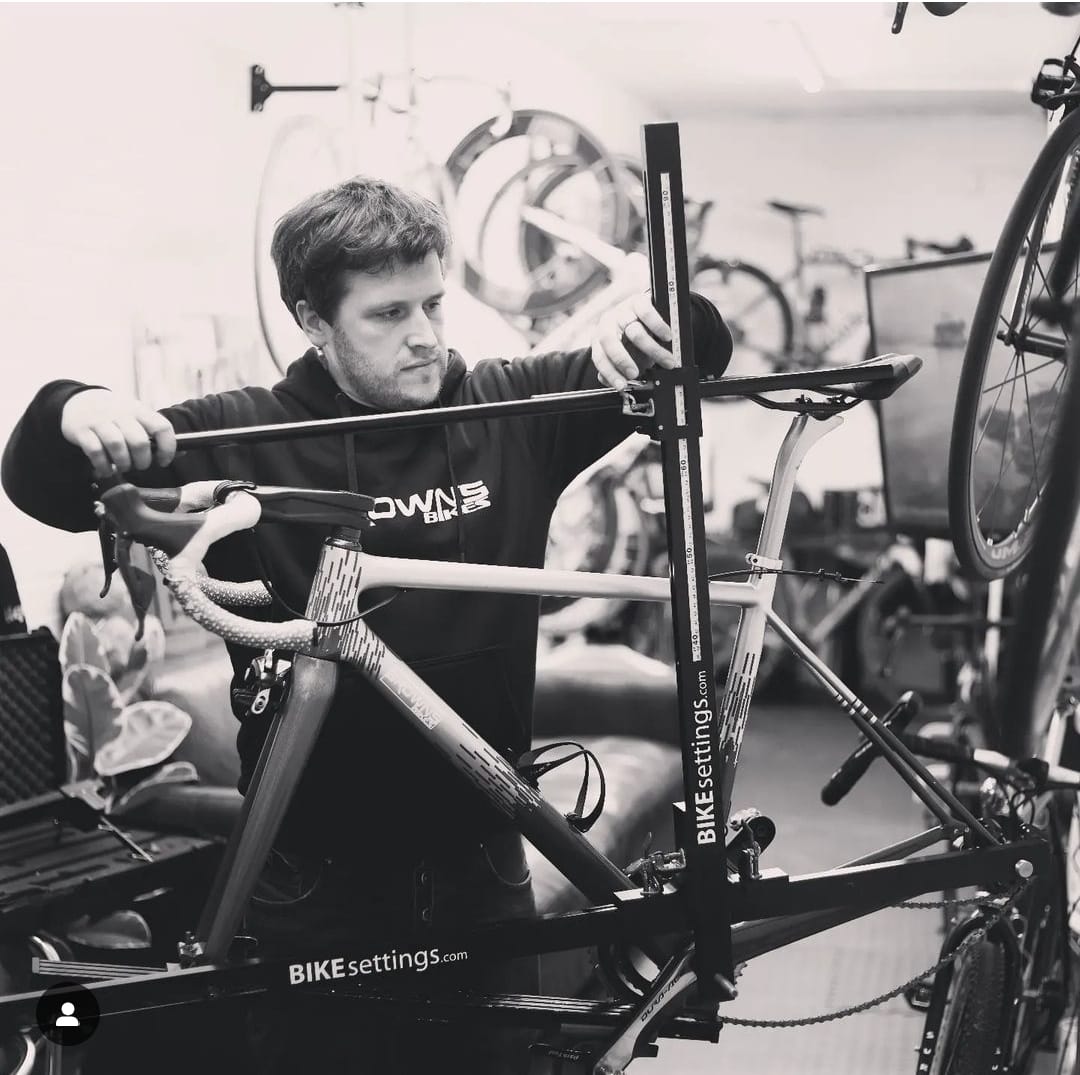 Professional bicycle mechanic servicing a performance bike