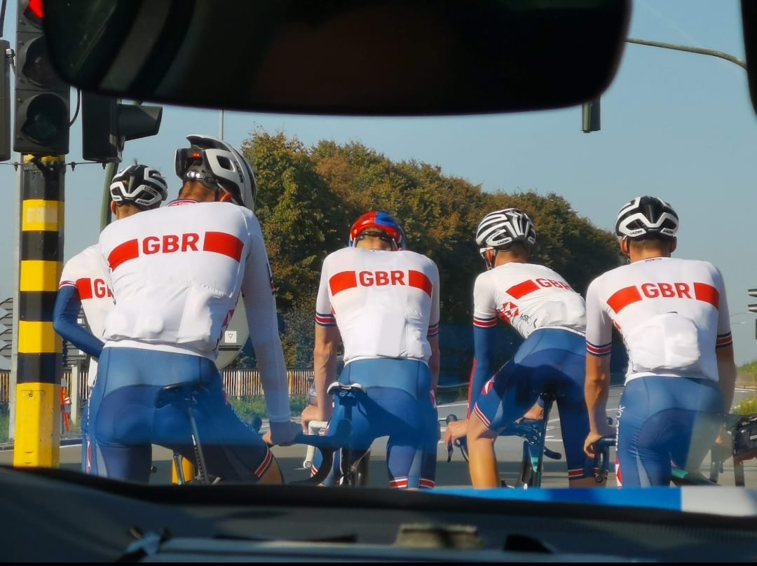 Brown working carefully on a bicycle